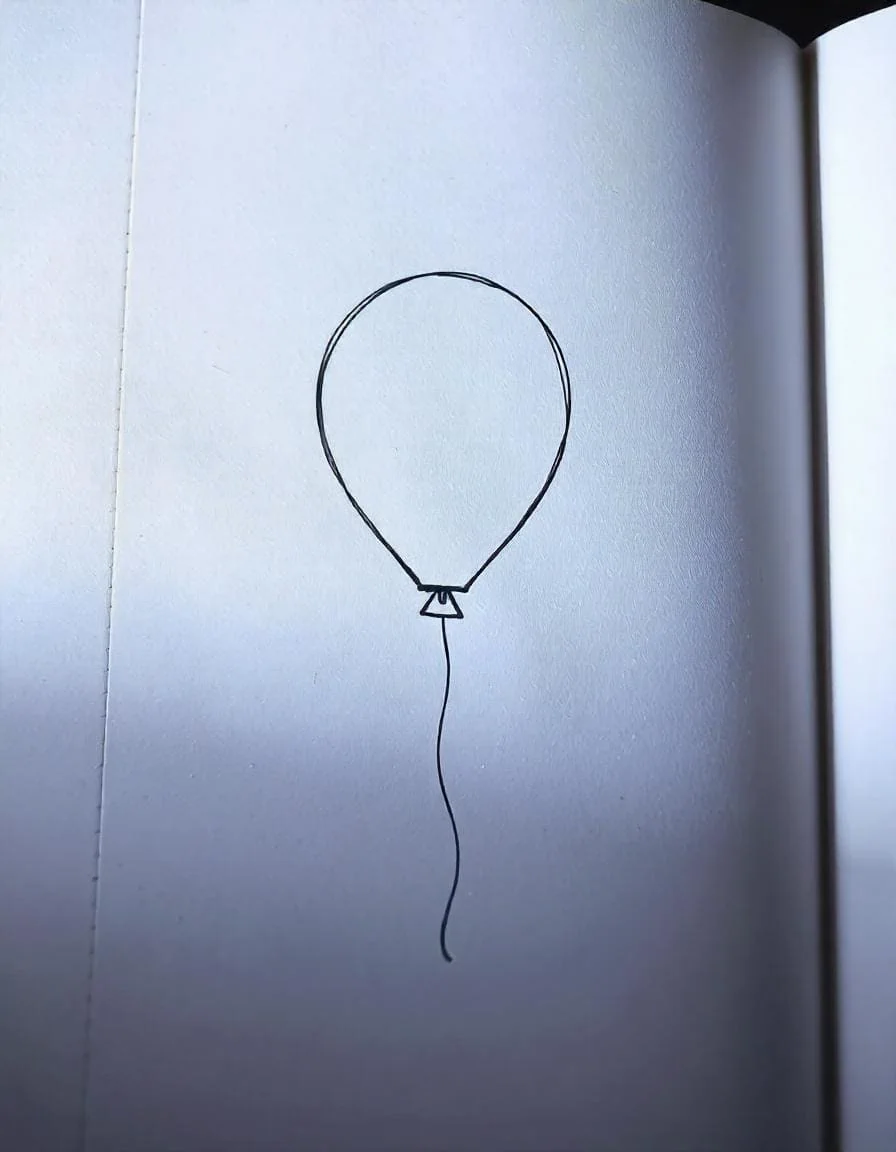 A unique triangular-shaped balloon with rounded edges and a slightly curved string, offering a playful and distinctive look